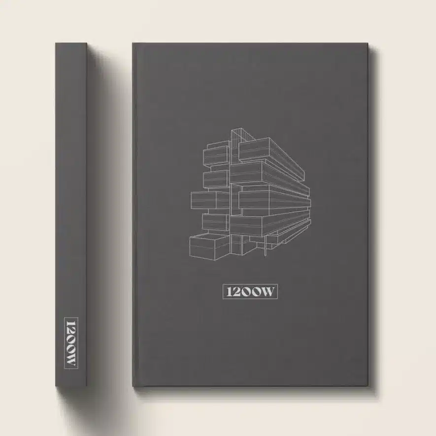 Hardcover book with dark cover featuring a minimalist architectural drawing and 1200W logo
