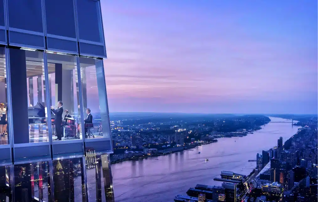 Live musicians performing inside Peak restaurant with floor-to-ceiling windows overlooking the Hudson River