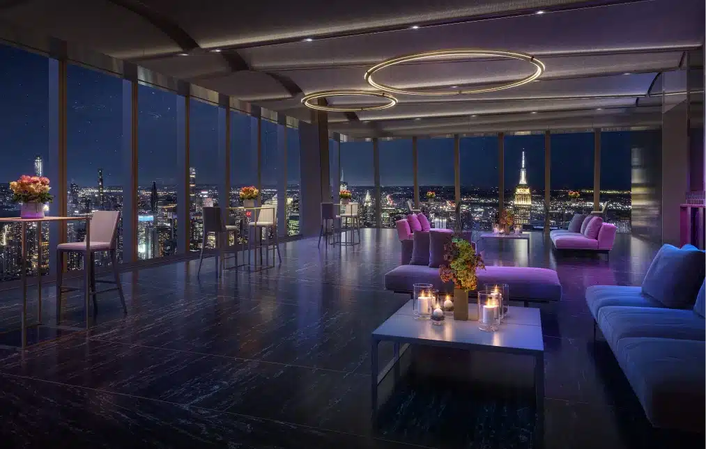 A stylish event space at Peak with soft lighting, plush seating, and floor-to-ceiling windows