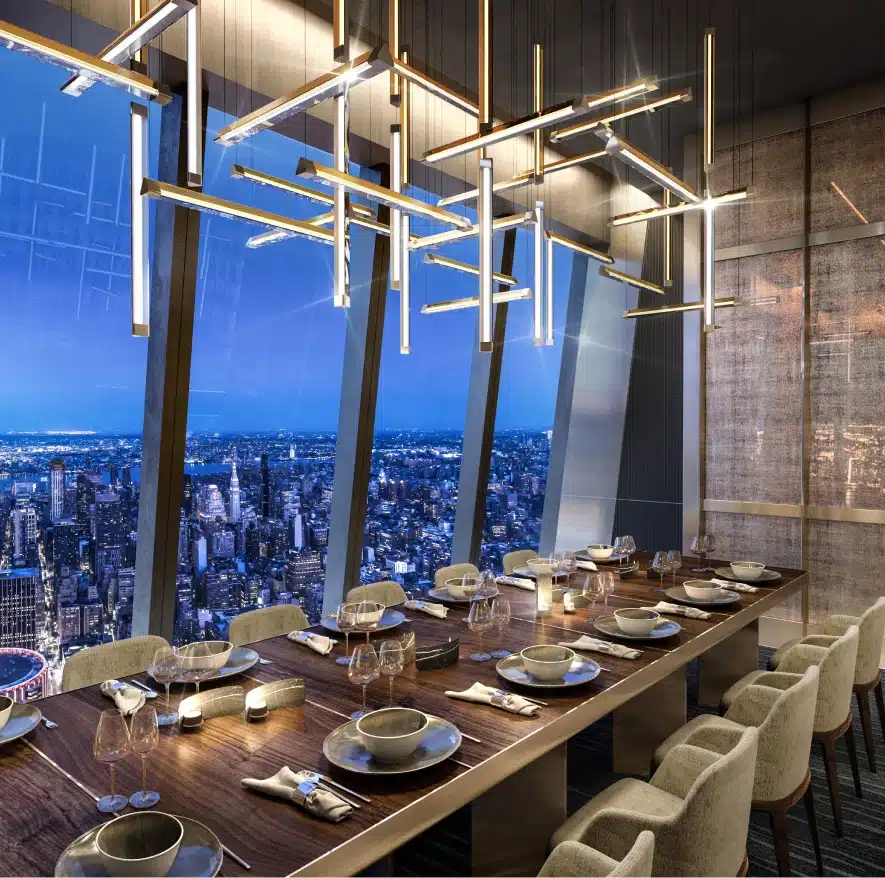 Modern chandelier lighting over a refined dinner setup with an aerial view of Manhattan