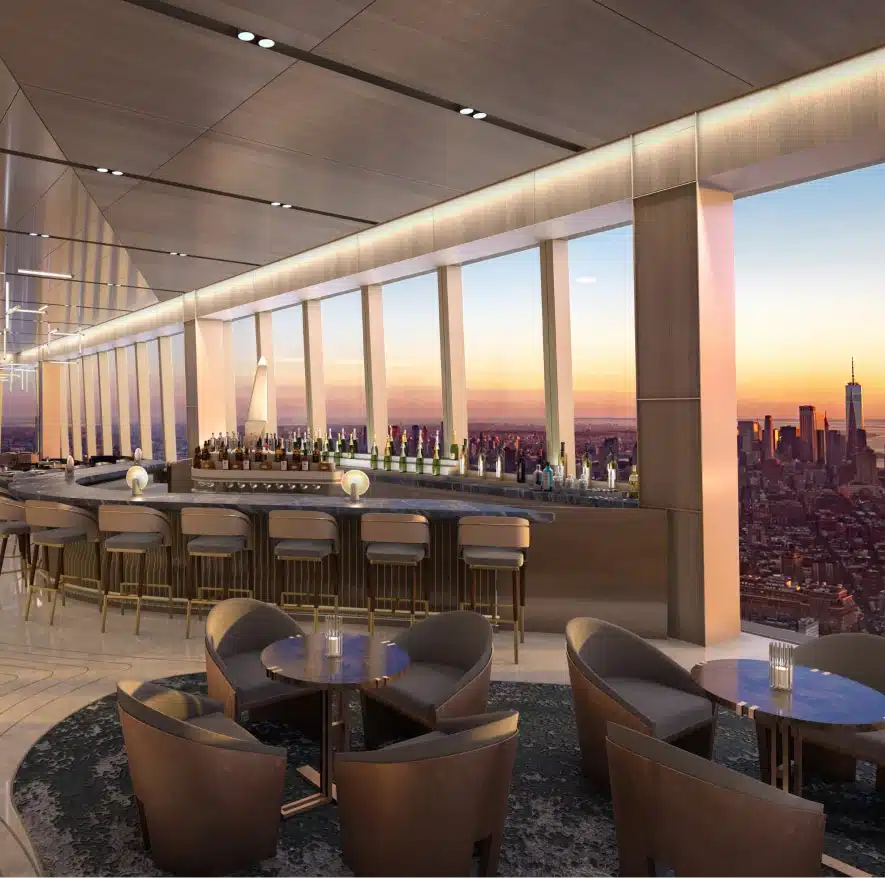 Cocktail lounge at Peak, featuring elegant seating, a stocked bar, and panoramic city vistas