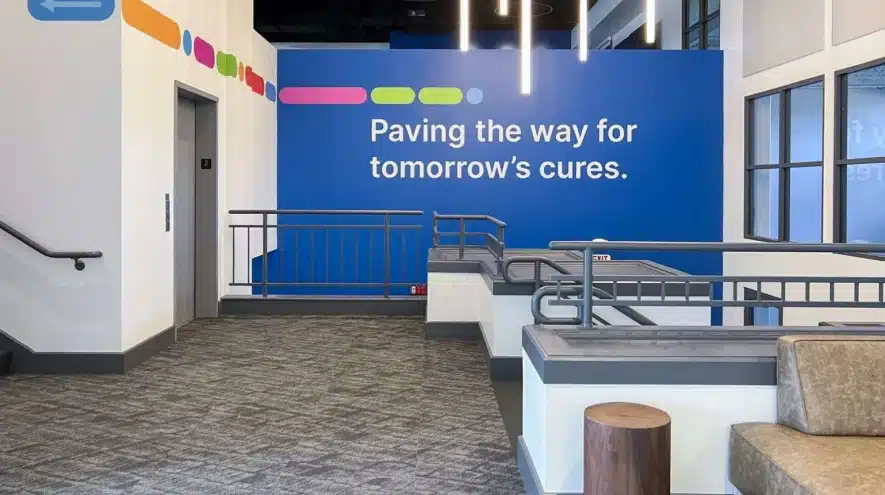 Interior design of a biotech office space featuring modern signage and colorful branding elements