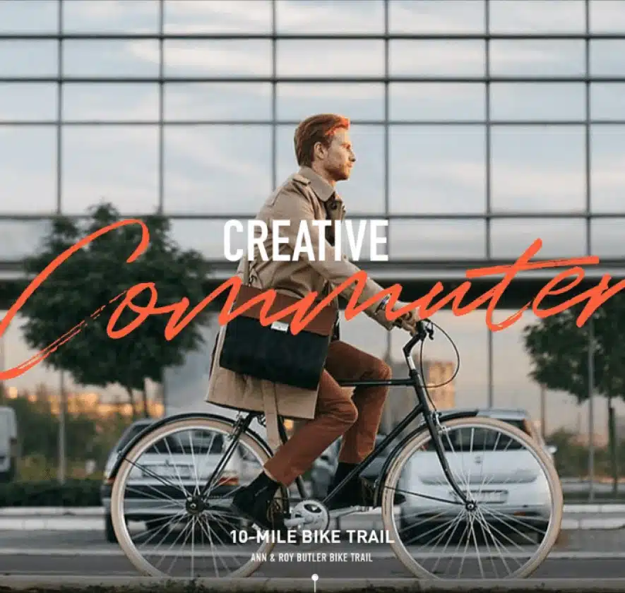 Professional commuter biking past a modern office building, representing The Republic’s work-life balance