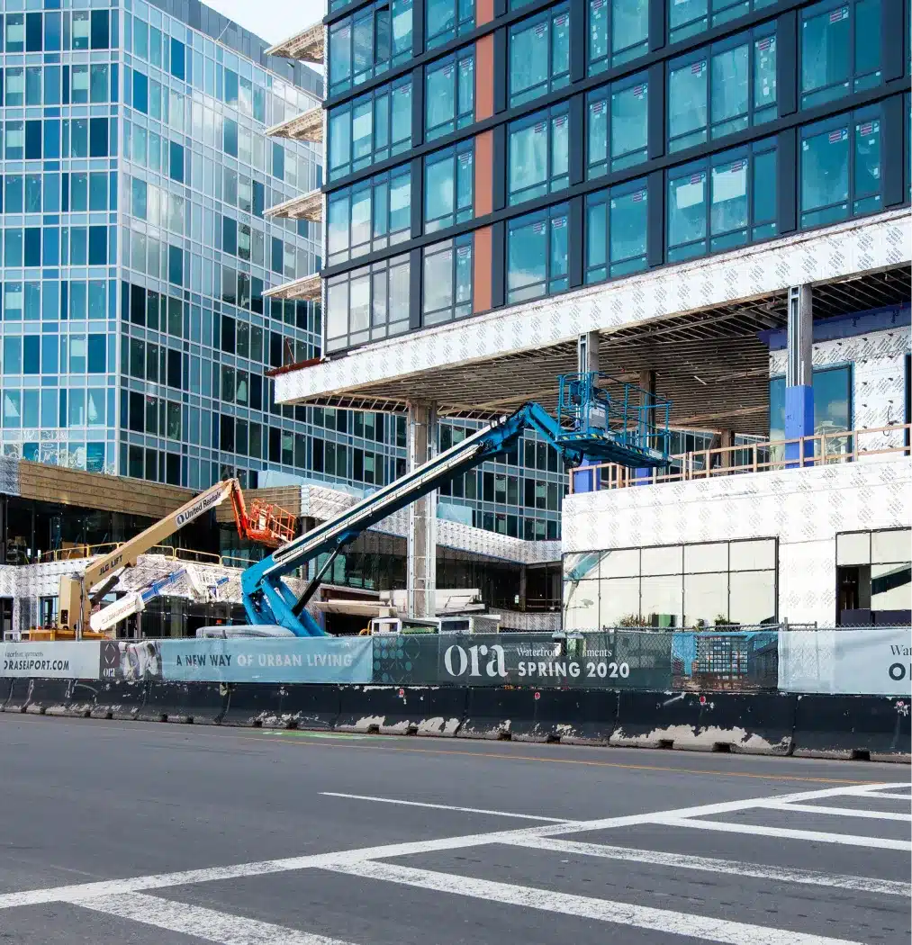 Construction site of Ora Seaport’s modern high-rise apartments with cranes and scaffolding in view