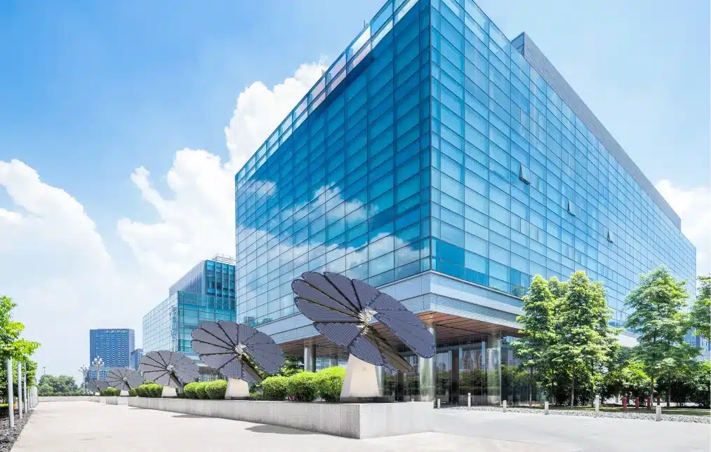 Corporate office building with multiple SmartFlower solar panels installed for renewable energy and sustainability