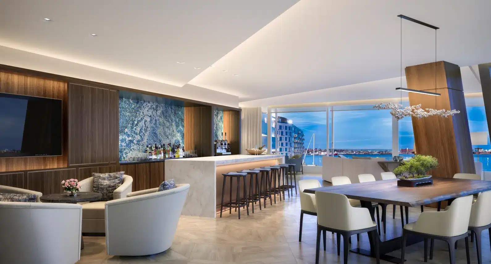 Upscale penthouse bar and lounge with warm wood accents and ocean views
