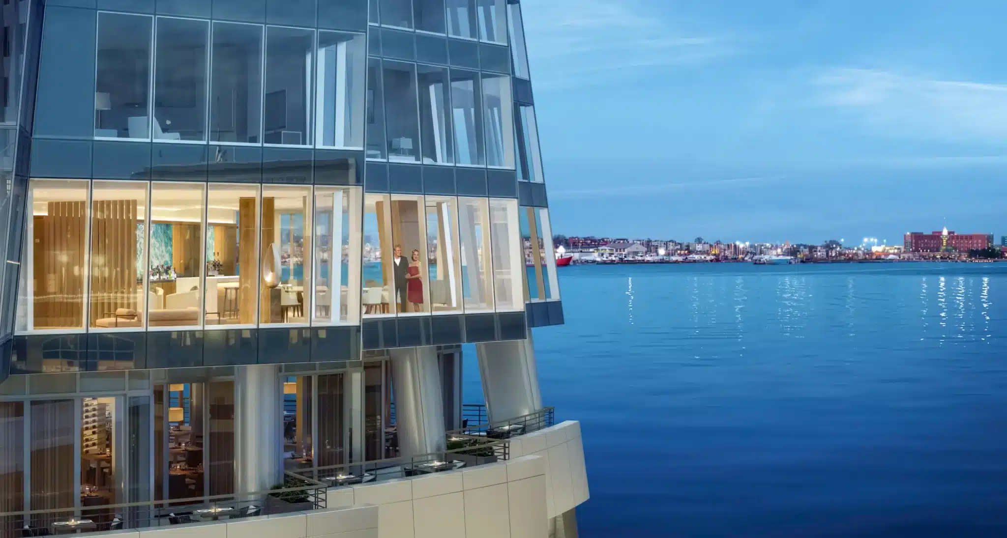 High-rise luxury residence with glass architecture overlooking the ocean at twilight