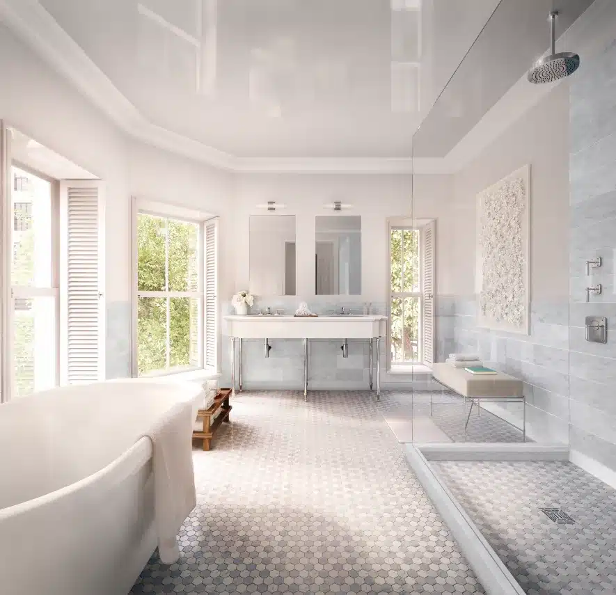 Elegant marble bathroom with dual sinks, hexagon tiles, and natural light from large windows