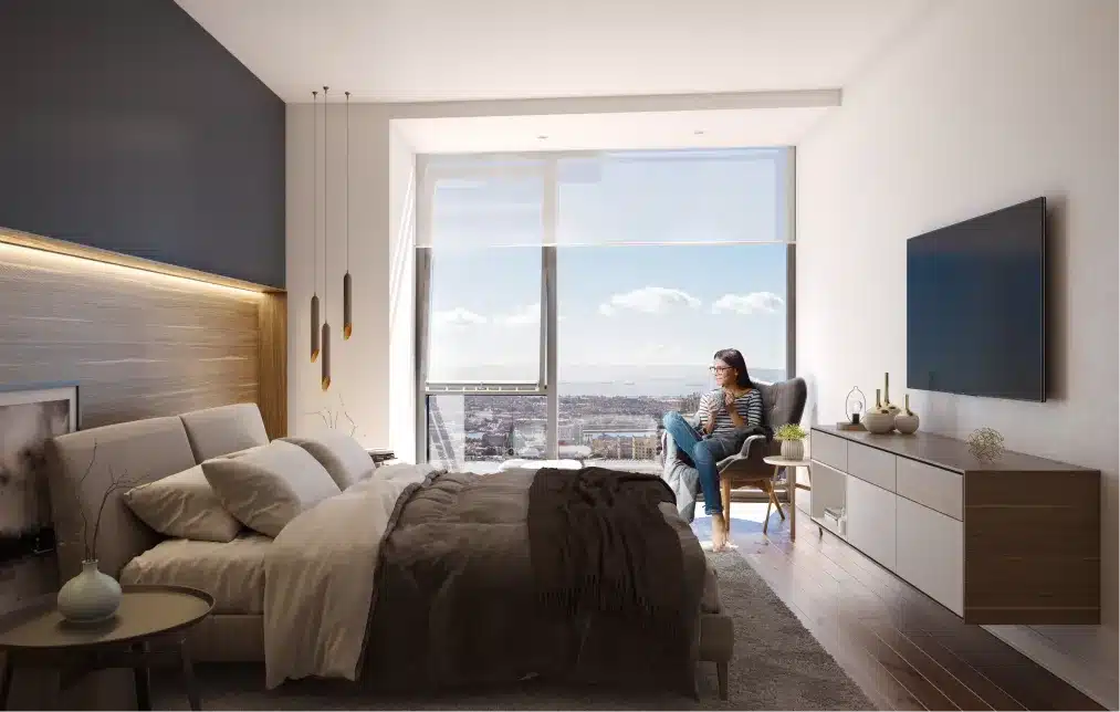 Modern bedroom with a city view, stylish decor, and a woman enjoying coffee near the window