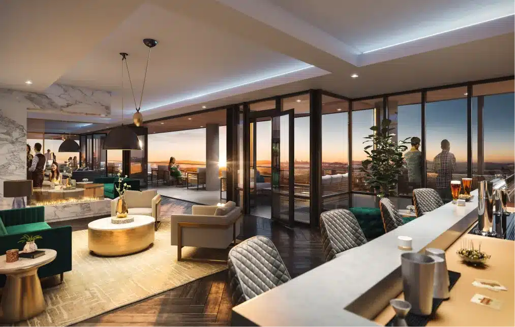 Upscale rooftop lounge with a sunset view, stylish seating, and a modern indoor-outdoor design