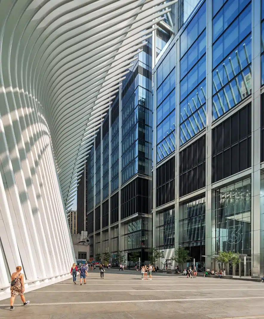 View from inside the Oculus looking out towards towering glass buildings and urban life