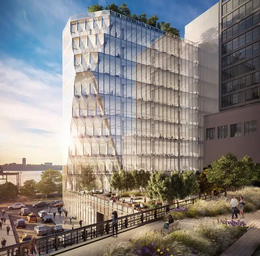 Modern glass office building with geometric windows reflecting sunlight near an urban park