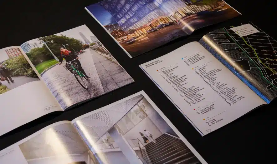 Printed marketing materials highlighting urban lifestyle, office design, and city infrastructure