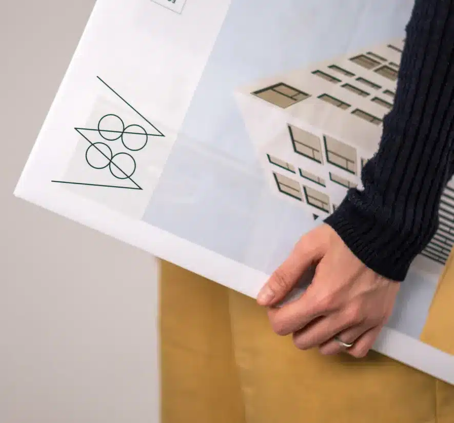 Close-up of a person holding a printed real estate branding piece for 88 Wareham condos