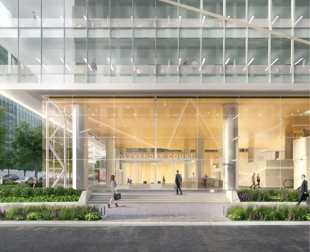 Alexander Court entrance featuring a modern glass facade, sleek columns, and green landscaping