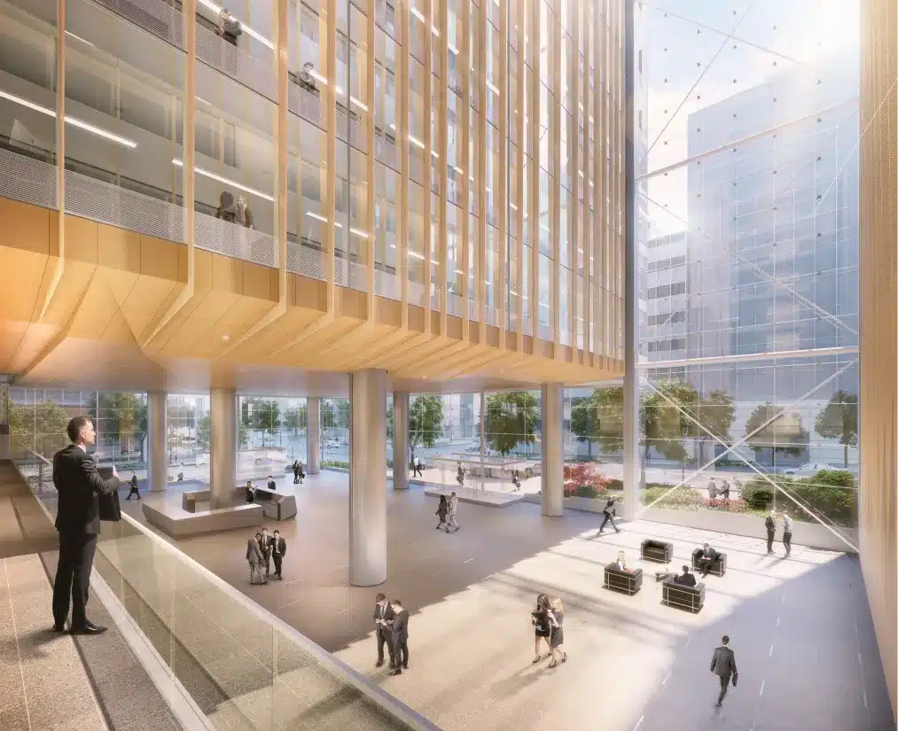 Spacious lobby with towering glass walls, open atrium, and elegant wood-paneling