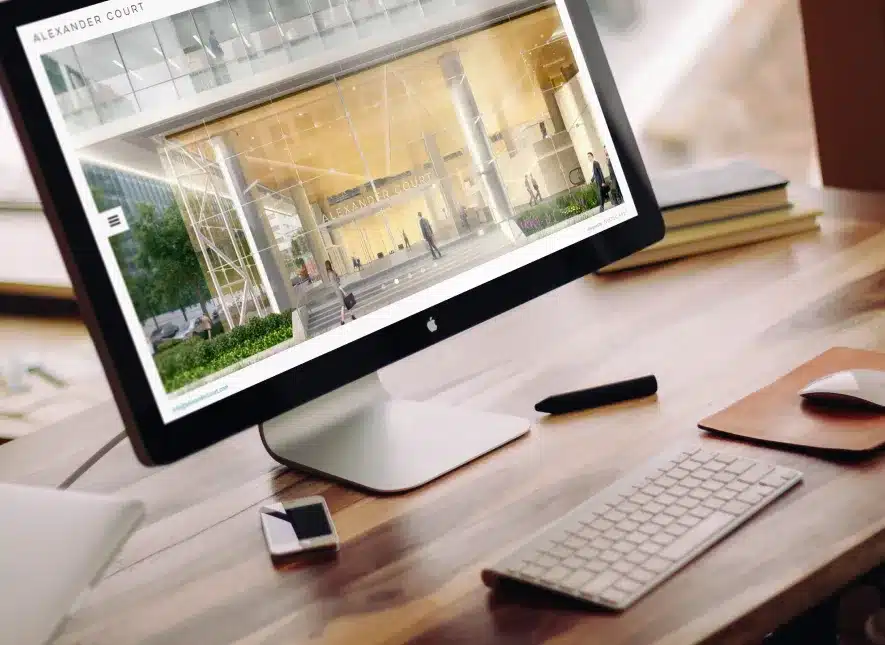 Apple desktop displaying Alexander Court's official website with modern office building imagery