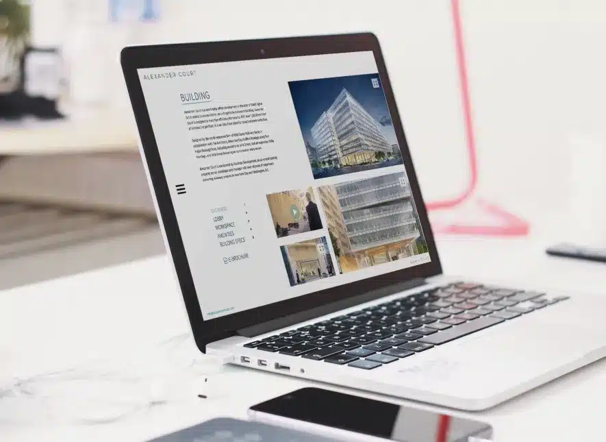 Laptop displaying the Alexander Court website, featuring building details and workspace information