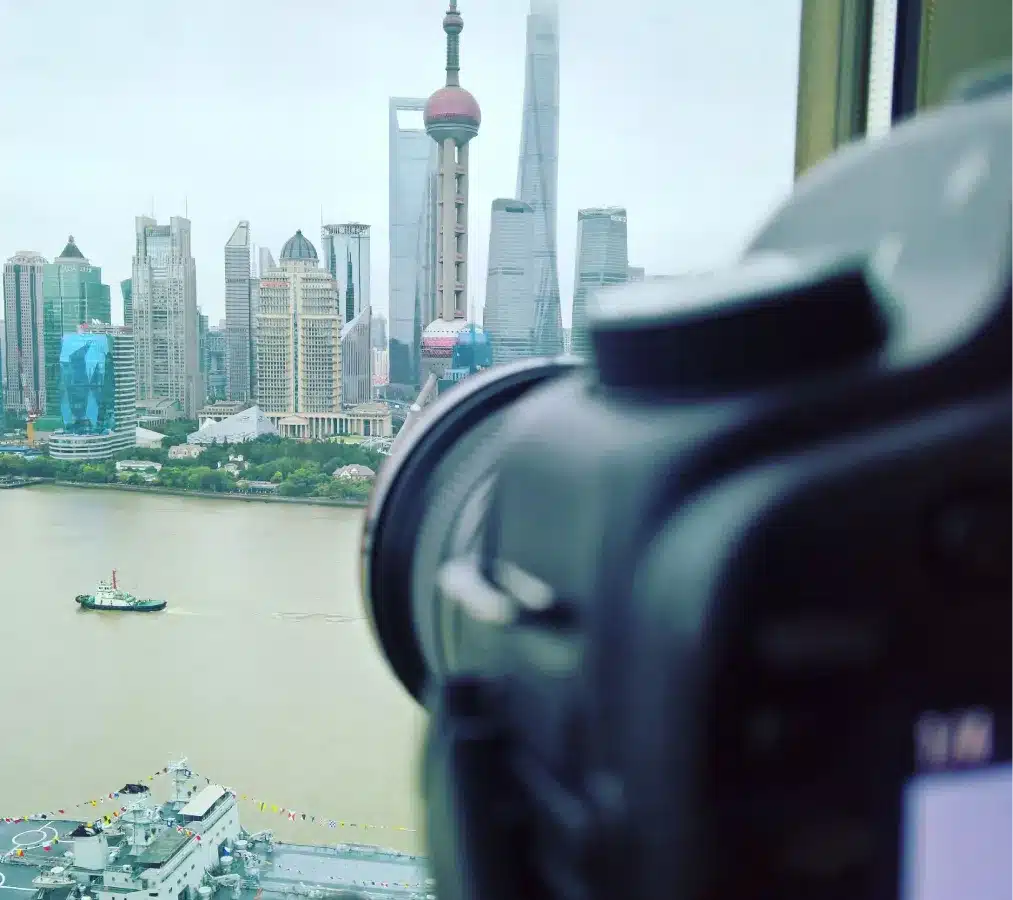 Photographer’s view of Shanghai’s skyscrapers through a camera lens on a cloudy day