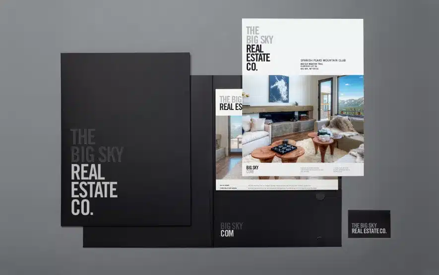 Sophisticated real estate company branding with stylish black folders and property brochures