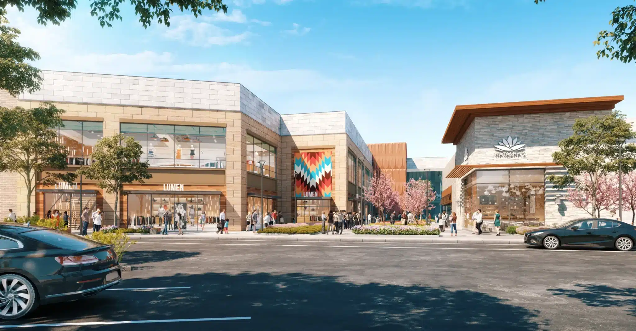 Wide view of a contemporary shopping district with stylish storefronts and landscaped walkways