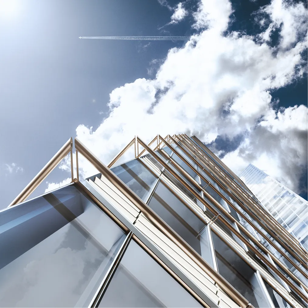 Low-angle view of a modern glass skyscraper reflecting the blue sky and dramatic cloud formations