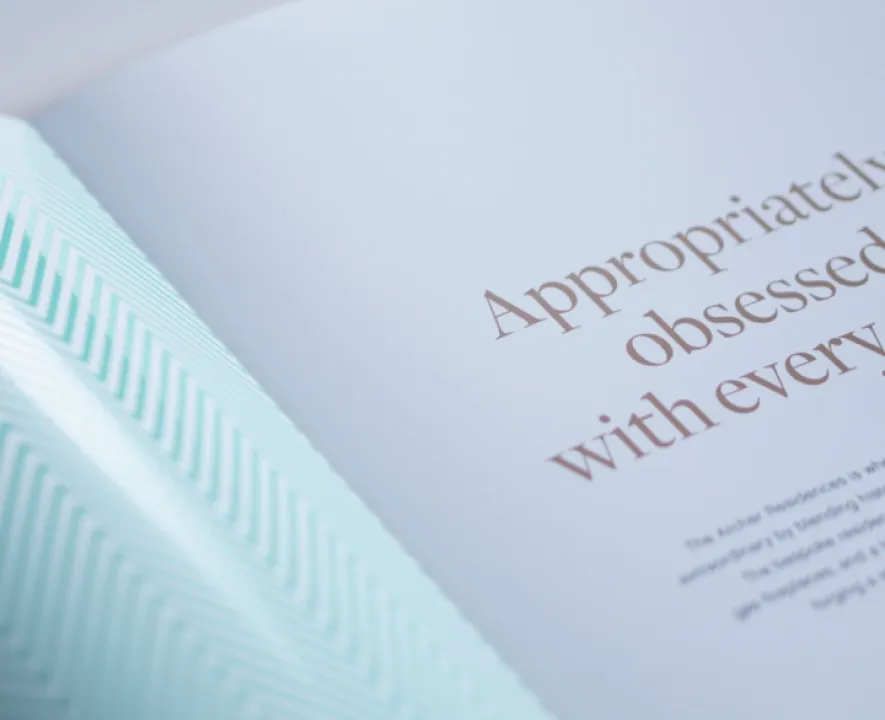 Close-up of luxury booklet showcasing elegant typography and a subtle geometric pattern