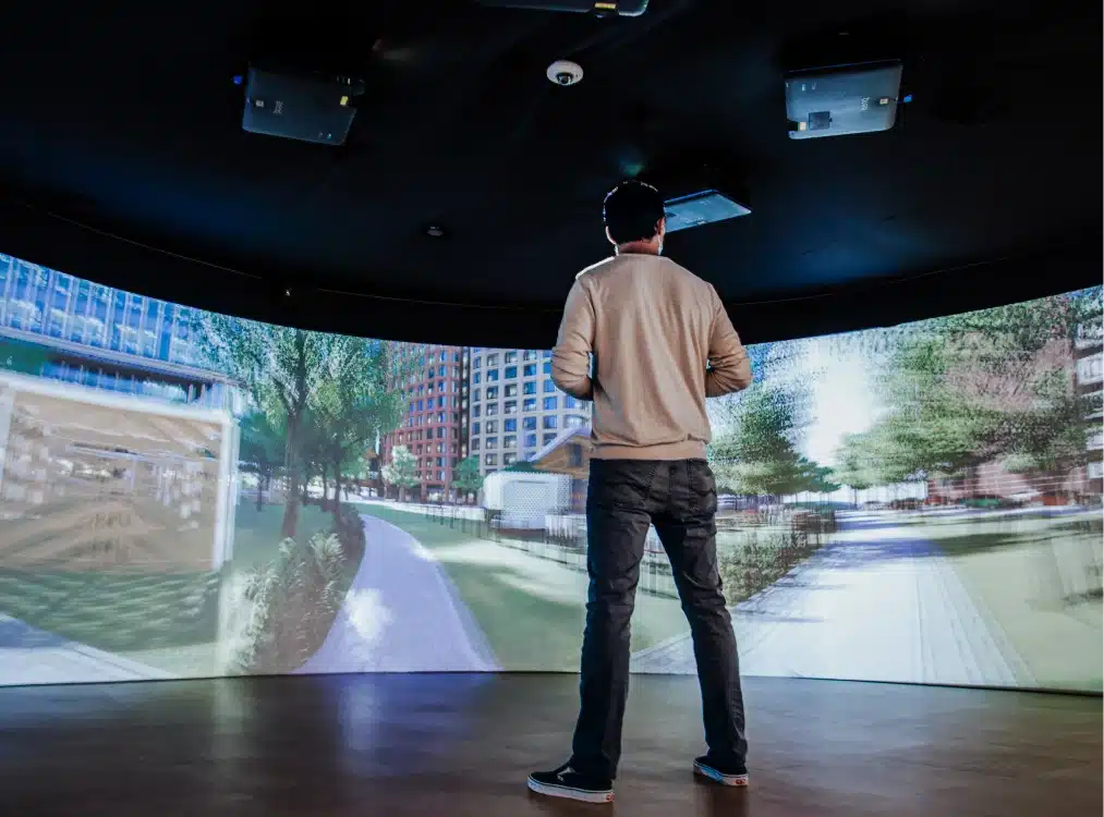 Man viewing architectural visualization inside immersive 360-degree digital projection room