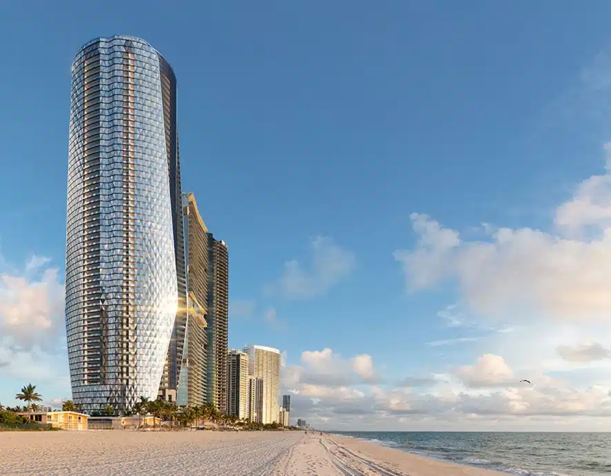 Oceanfront Bentley Residences tower with a shimmering glass exterior along the sandy coastline