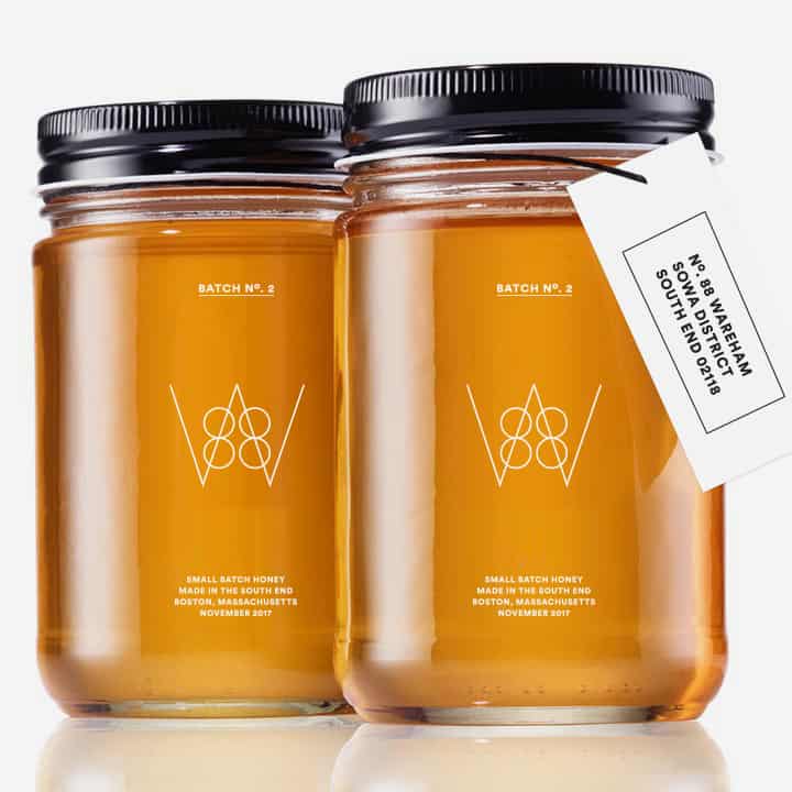 Two glass jars filled with golden honey featuring stylized 88W logo and minimalist label