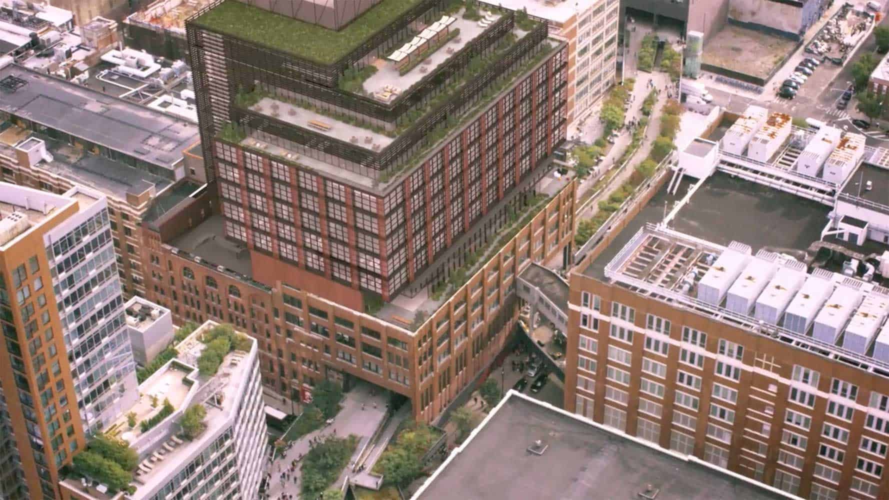 Aerial view of modern urban office building featuring multiple green rooftop terraces and red brick façade
