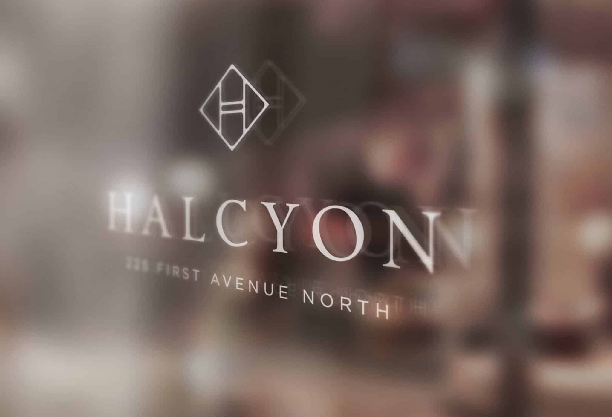 HALCYON logo on glass surface with blurred background and white modern lettering details