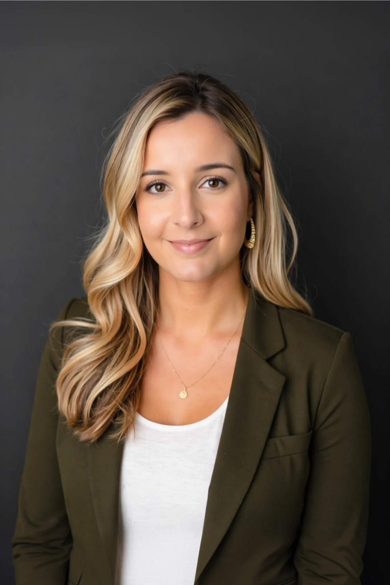 Modern executive portrait showcasing female professional with polished appearance and natural studio lighting composition
