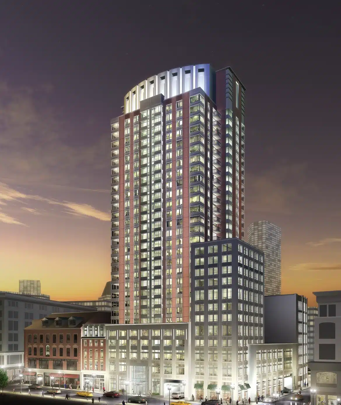Night view of modern corporate high-rise with surrounding street traffic and glowing urban lights