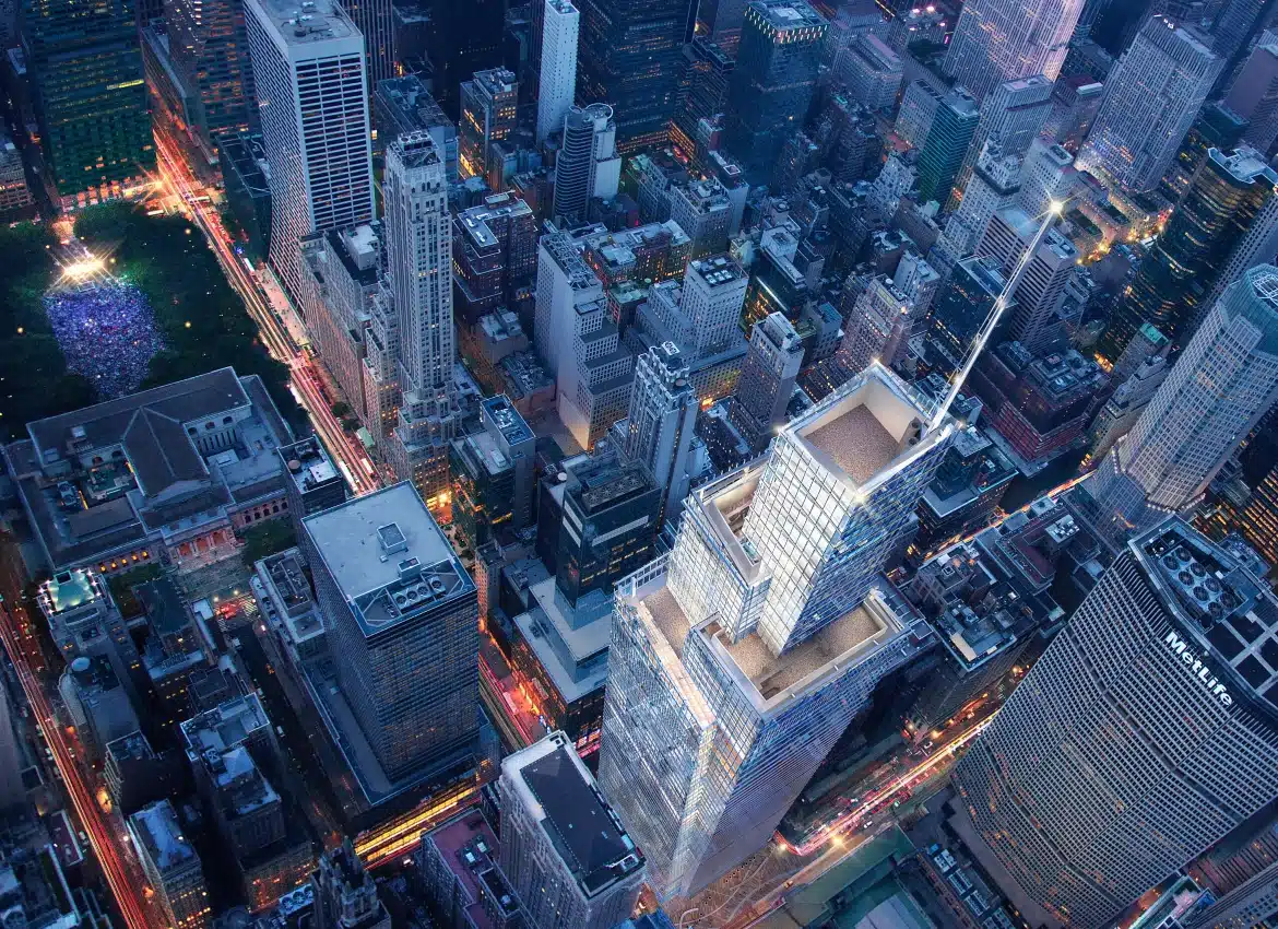 Aerial cityscape view highlighting One Vanderbilt tower illuminated among dense Manhattan skyline