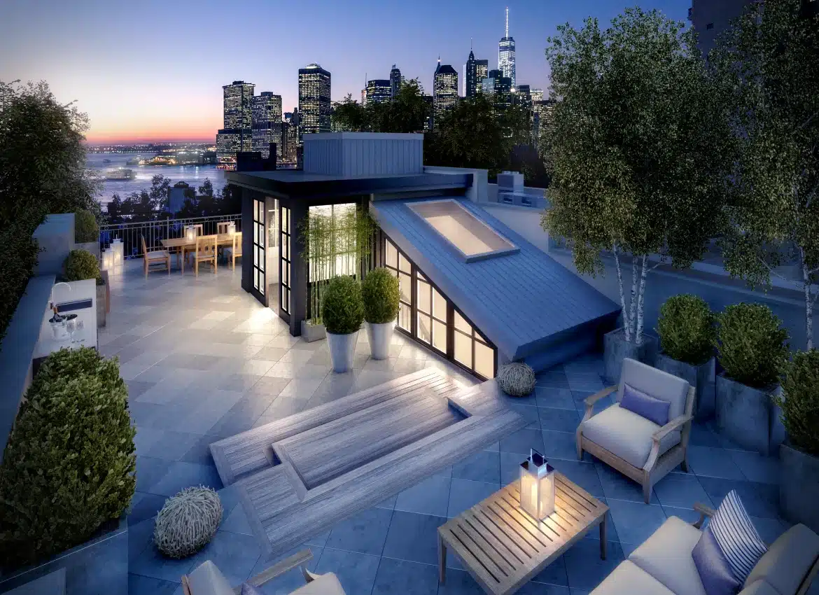 Rooftop terrace with outdoor seating and skyline views at sunset in New York City
