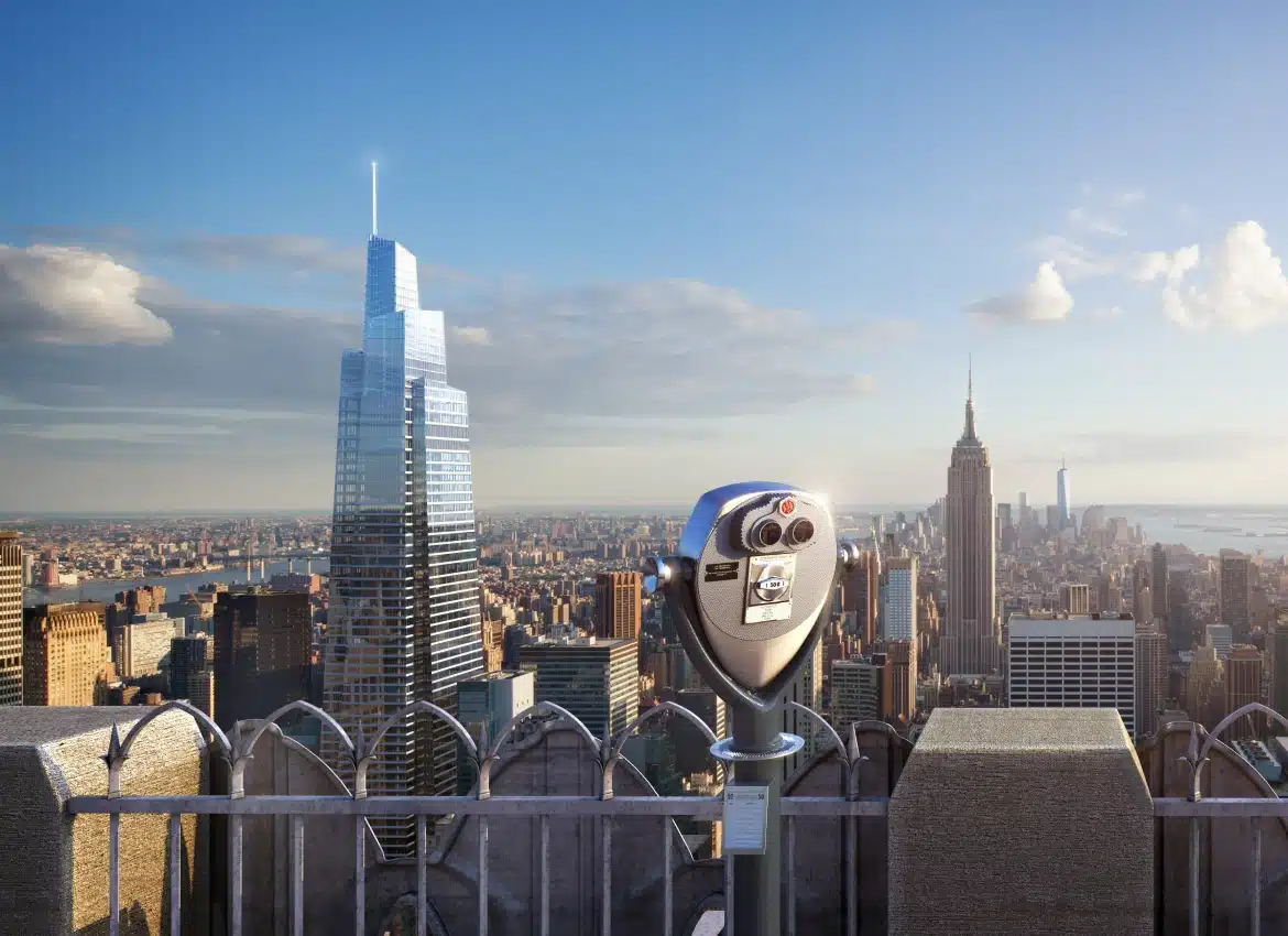 City skyline view with One Vanderbilt skyscraper and Empire State Building under clear sky