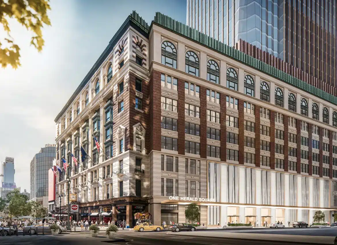 Historic One Herald Square building featuring detailed architecture and bustling New York street scene