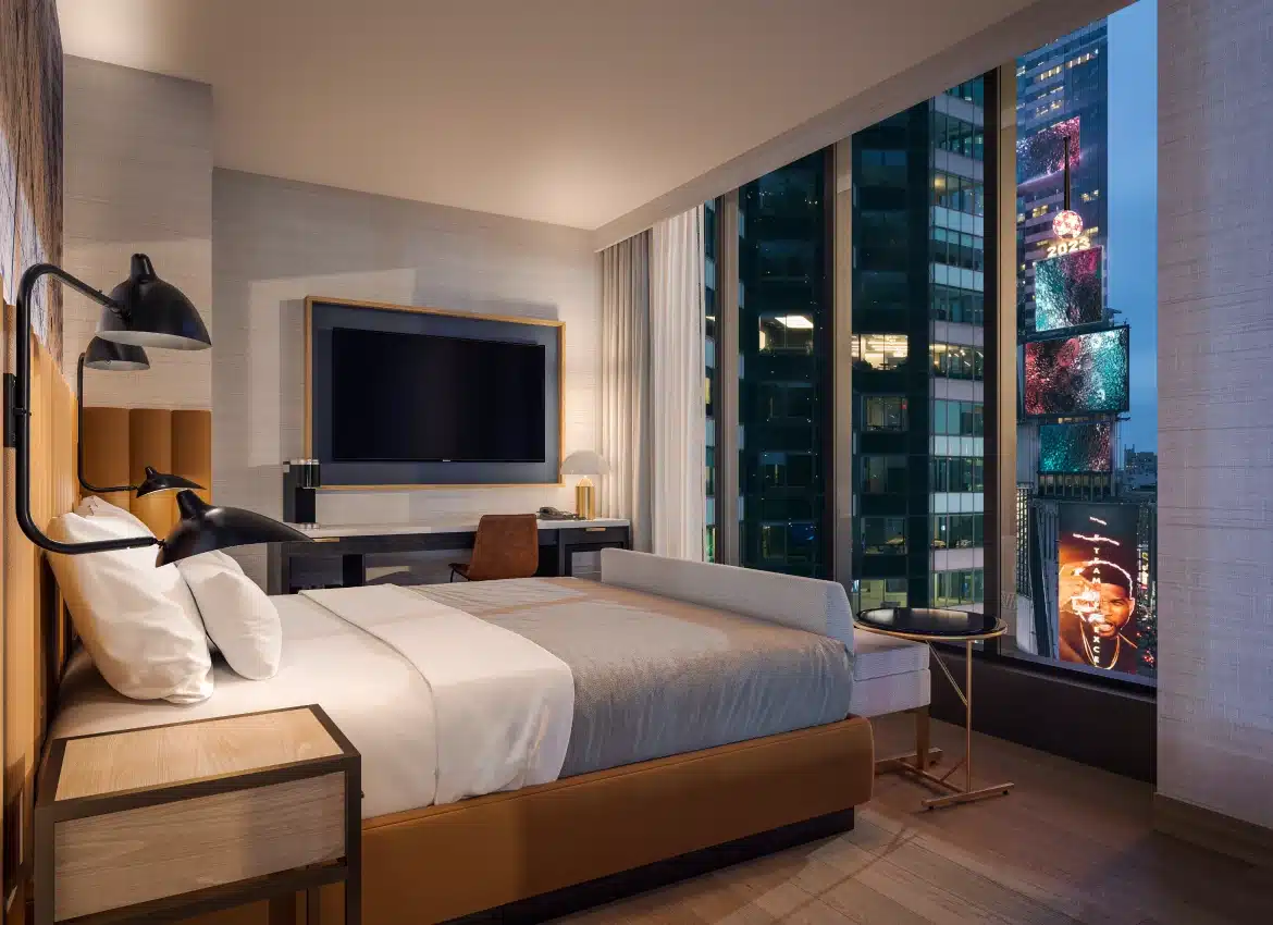 Modern hotel guest room in Times Square featuring city views and stylish contemporary furnishings