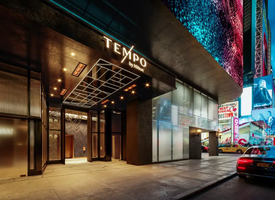 Tempo by Hilton Times Square entrance with illuminated signage and bright Broadway district lights