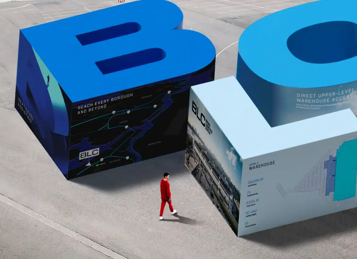 Large three-dimensional BLC promotional installation rendering featuring warehouse logistics graphics and walking visitor