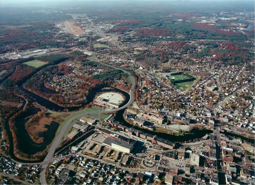 High-resolution aerial view of city with winding river and mix of residential and urban zones