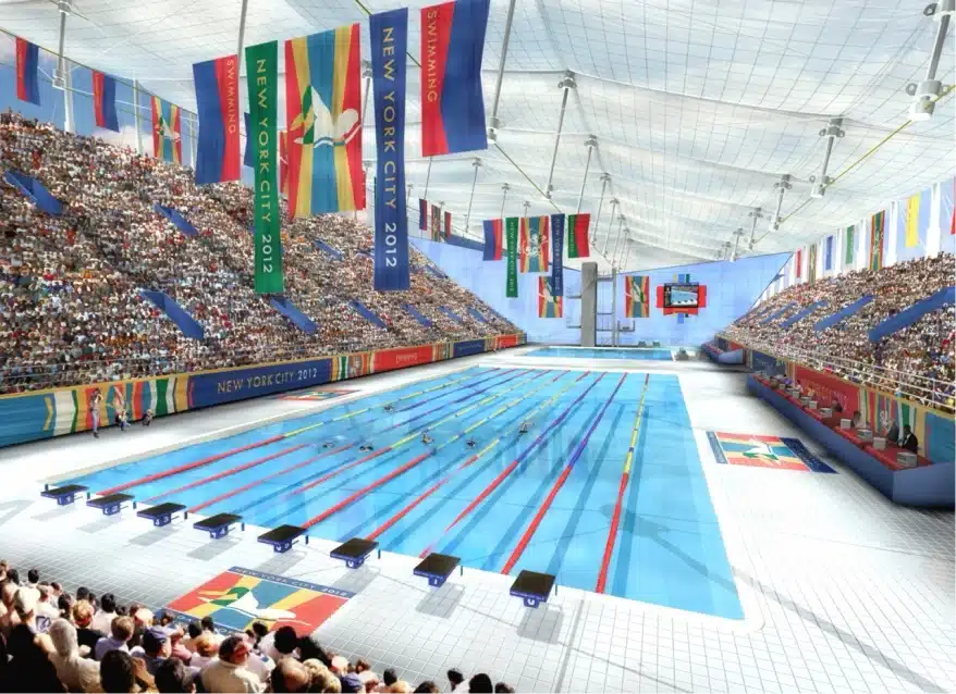 Olympic swimming pool filled with athletes competing as spectators watch from grandstands under colorful banners