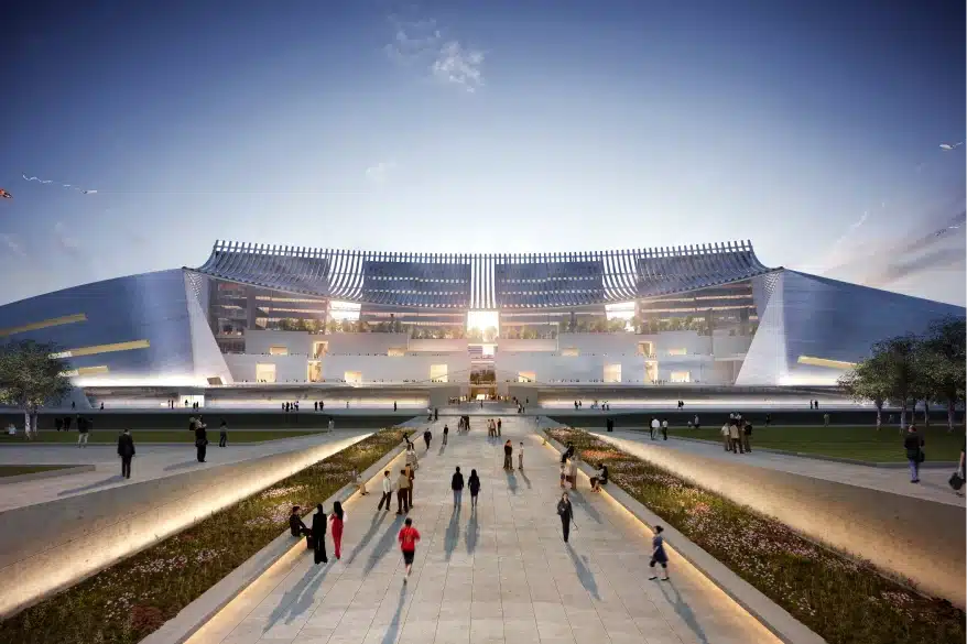 Futuristic stadium exterior with sleek architectural design and wide pedestrian entrance pathway at sunset