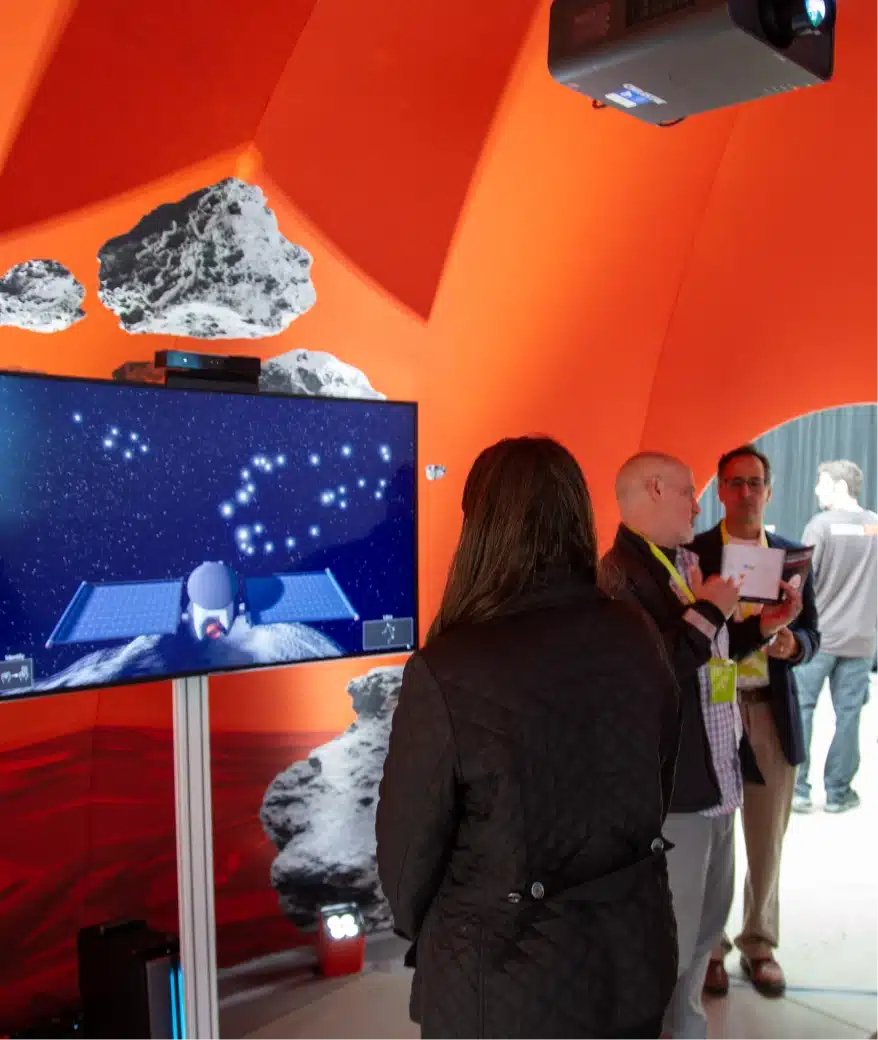 People watching digital projection of spacecraft exploring asteroids inside immersive exhibition dome