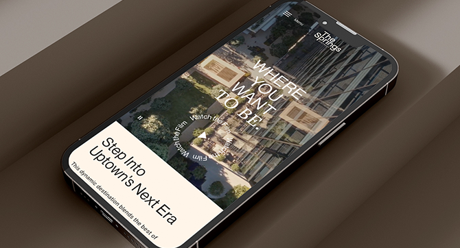 Modern smartphone displaying luxury apartment website homepage with contemporary building imagery and elegant mobile interface