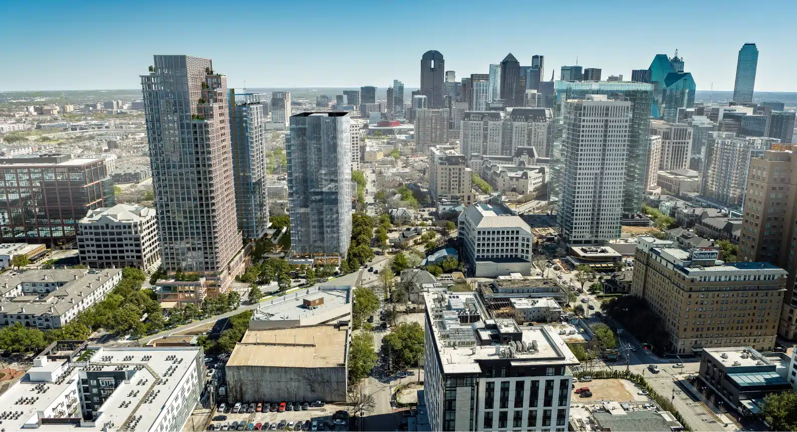 Downtown Dallas cityscape showcasing contemporary residential and office buildings with expansive skyline under clear blue skies