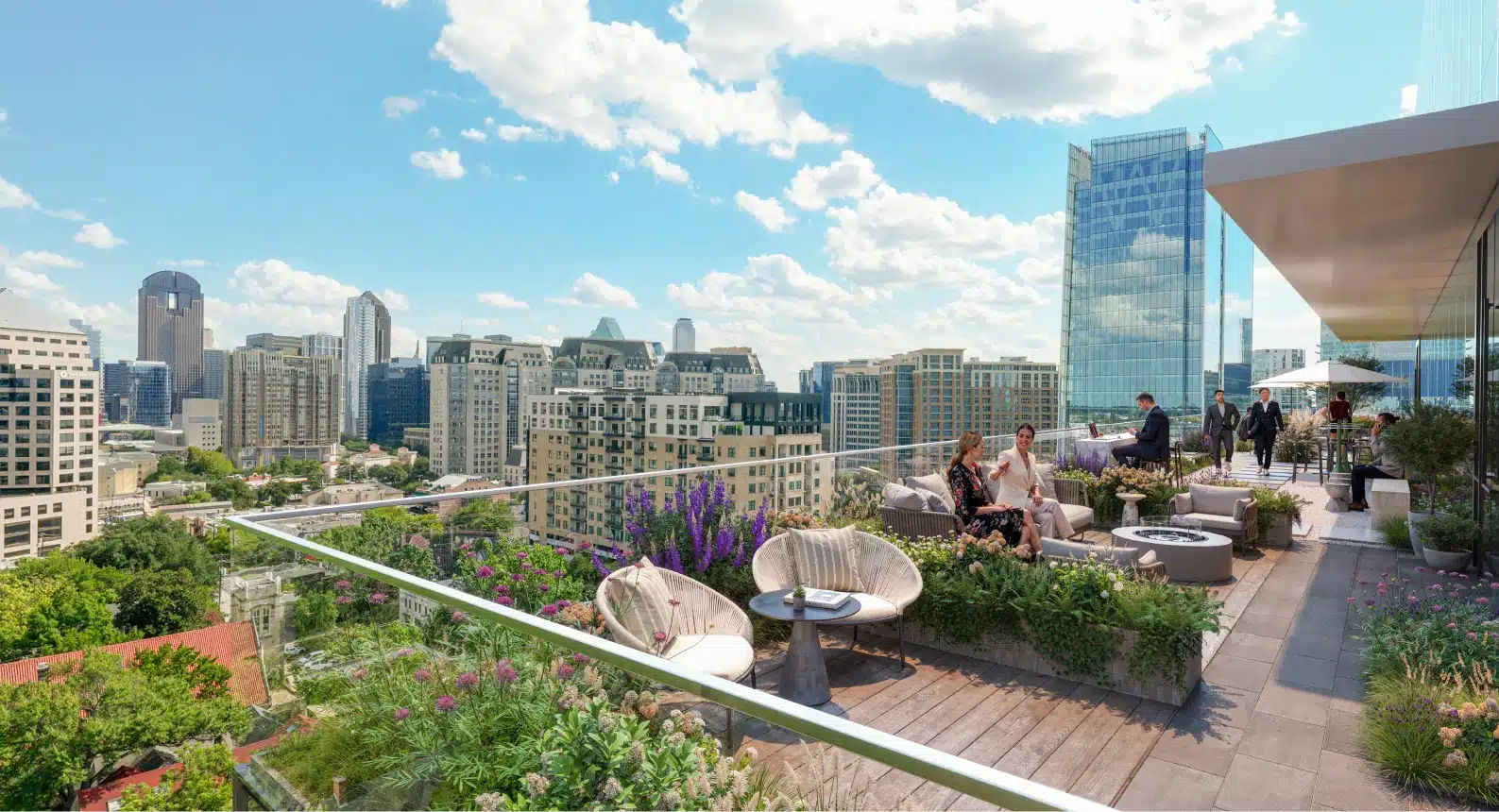 Modern residential rooftop amenity deck featuring outdoor lounge spaces landscaped gardens and panoramic Dallas skyline