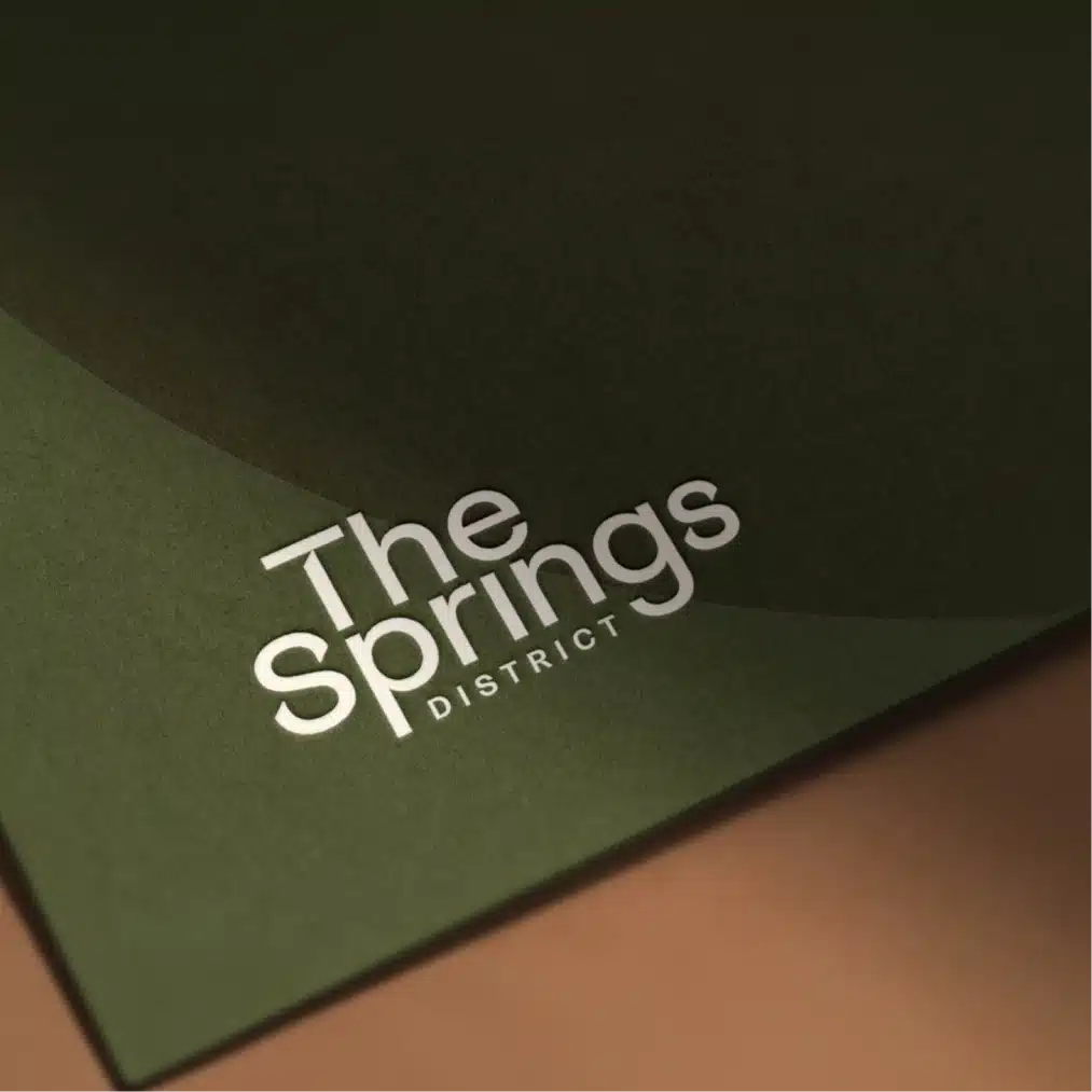 The Springs District brand identity displayed on elegant green stationery with contemporary minimalist design