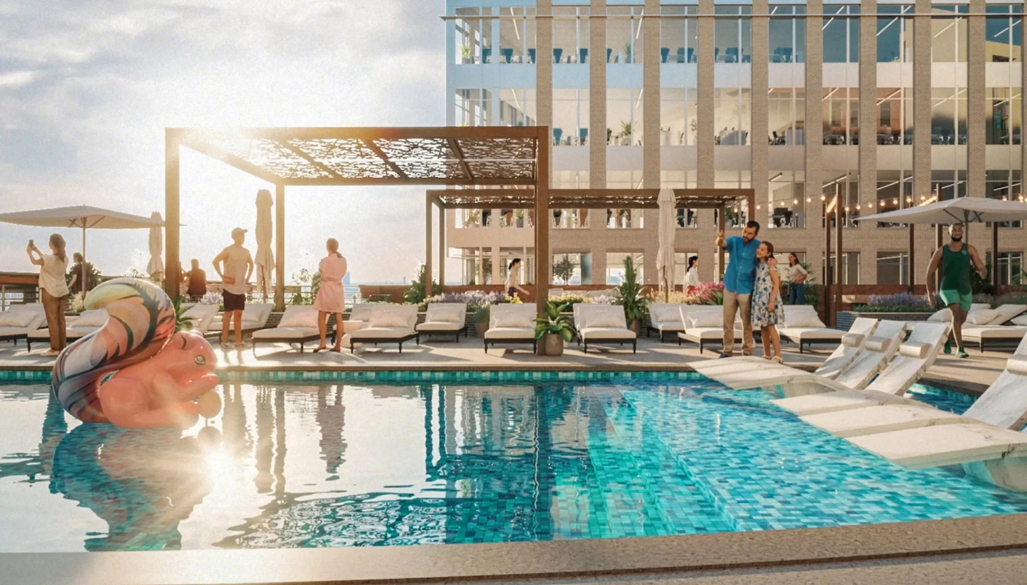 Resort-style rooftop pool featuring sun loungers, colorful float, and vibrant outdoor gathering spaces